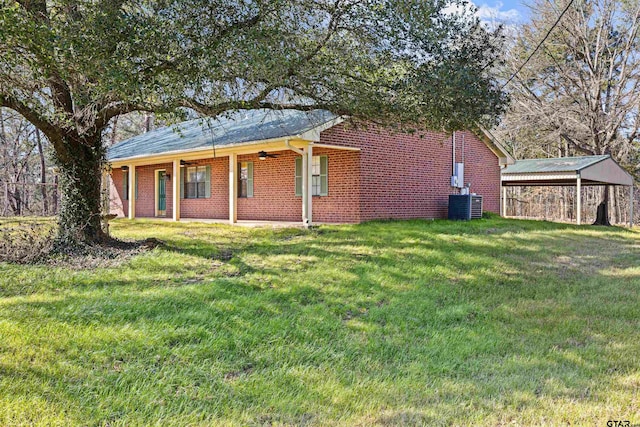 exterior space with central air condition unit and a front lawn