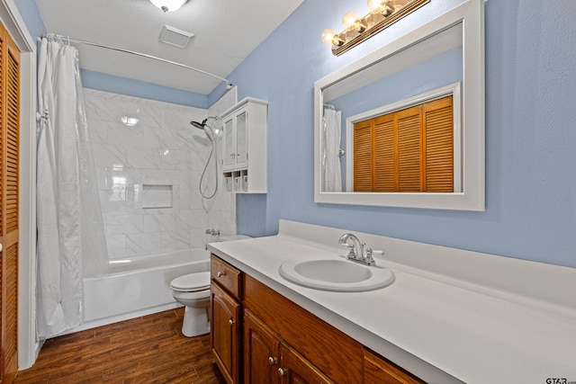 full bathroom with hardwood / wood-style flooring, vanity, toilet, and shower / tub combo