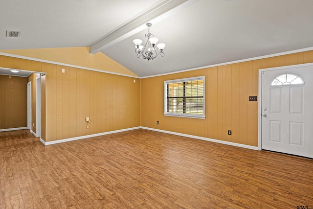 entryway featuring lofted ceiling with beams, an inviting chandelier, and hardwood / wood-style floors