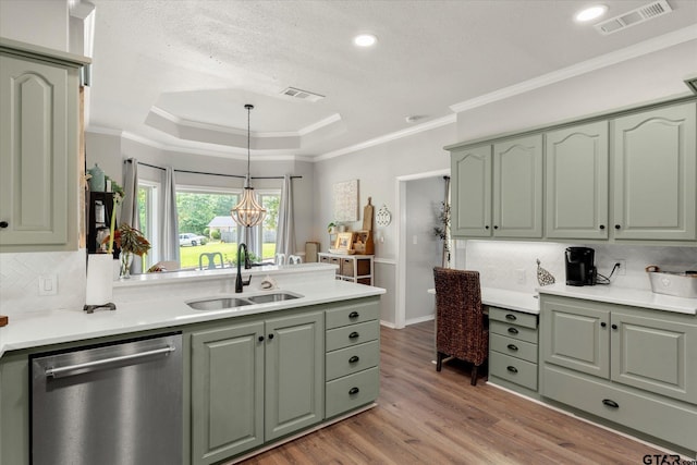 kitchen featuring green cabinets, decorative light fixtures, stainless steel dishwasher, and sink