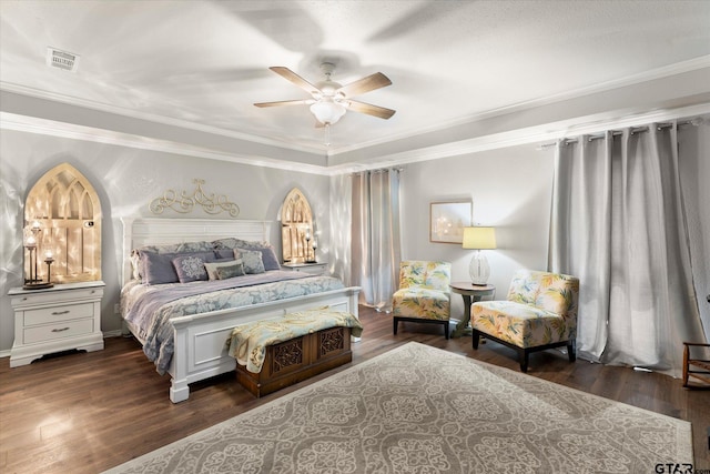 bedroom featuring dark wood-type flooring, ceiling fan, and crown molding