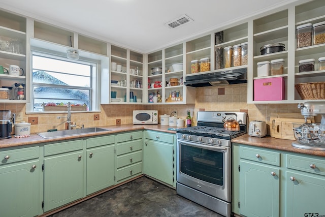 kitchen featuring sink, decorative backsplash, stainless steel range with gas cooktop, and green cabinets