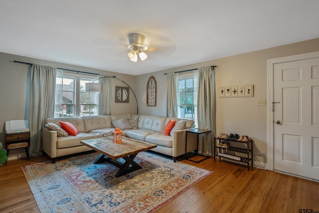 living room featuring ceiling fan and light wood-type flooring