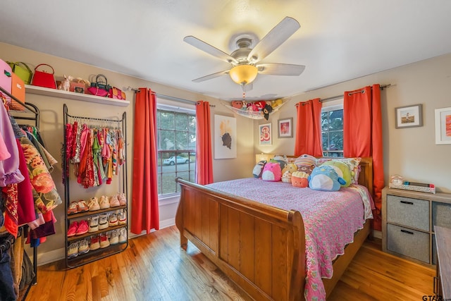 bedroom with ceiling fan and light wood-type flooring