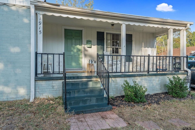 view of exterior entry with covered porch