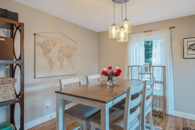 dining space with light hardwood / wood-style floors