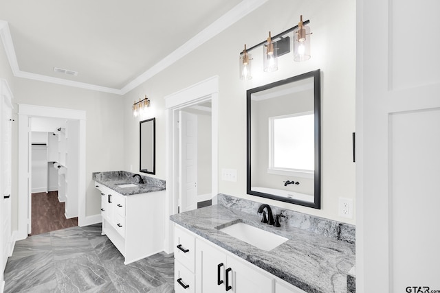 bathroom with ornamental molding and vanity