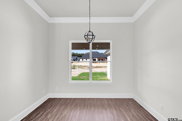 unfurnished dining area with crown molding, dark hardwood / wood-style floors, and a notable chandelier