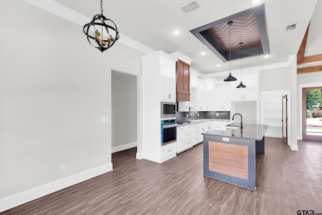 kitchen with sink, crown molding, a kitchen island with sink, white cabinetry, and stainless steel appliances