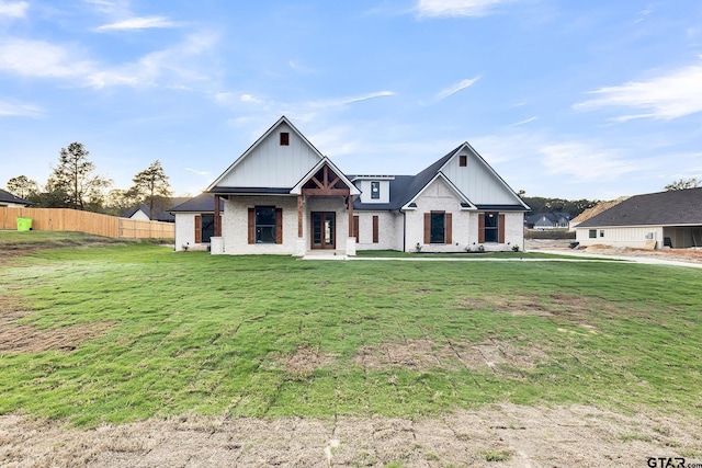 modern farmhouse style home featuring a front lawn