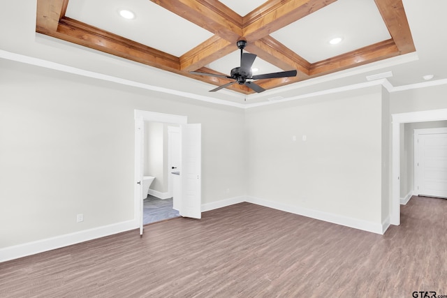 spare room featuring ceiling fan, hardwood / wood-style floors, beam ceiling, coffered ceiling, and ornamental molding