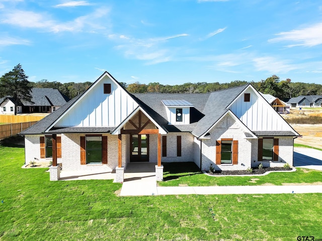 modern farmhouse style home with a front yard