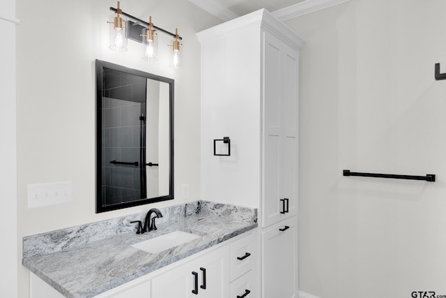 bathroom featuring crown molding and vanity