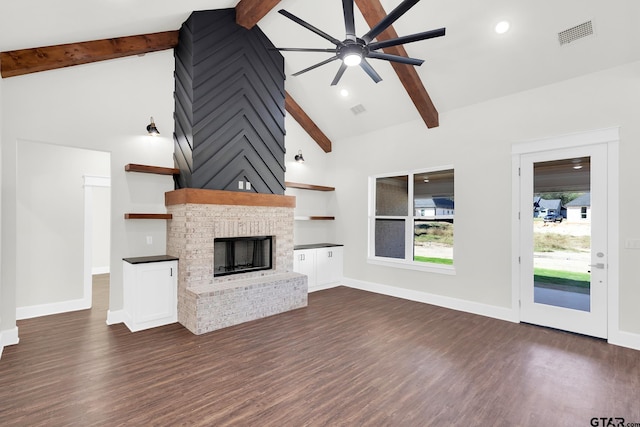 unfurnished living room featuring a brick fireplace, vaulted ceiling with beams, dark wood-type flooring, and ceiling fan