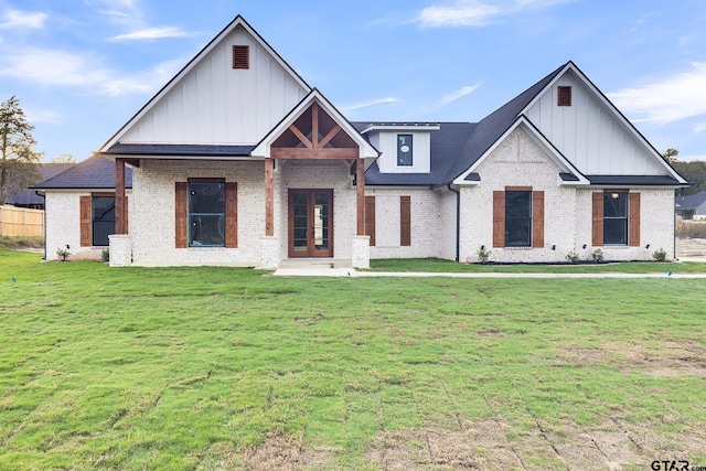 view of front of home featuring a front yard and french doors