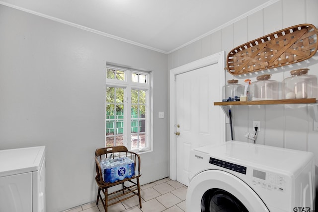 laundry area featuring washing machine and clothes dryer, a wealth of natural light, and ornamental molding