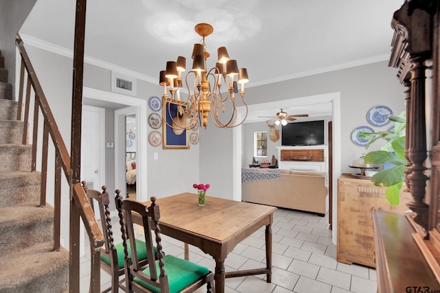 dining room featuring ceiling fan with notable chandelier and crown molding