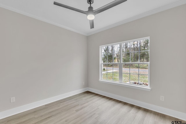 spare room with ceiling fan, a healthy amount of sunlight, light wood-type flooring, and ornamental molding