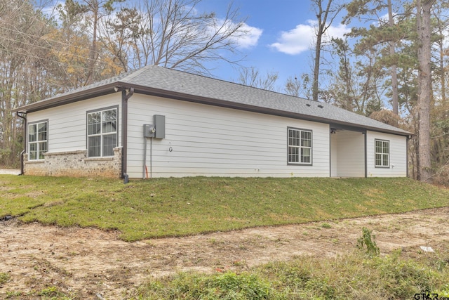 rear view of property with a yard