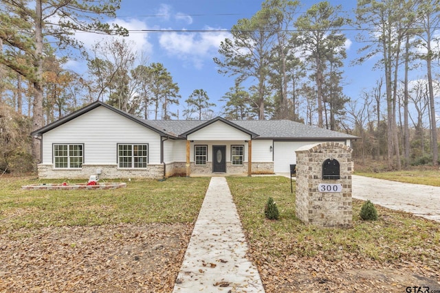 ranch-style home featuring a garage and a front yard