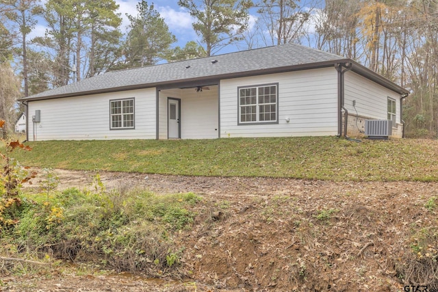 rear view of property featuring ceiling fan, a yard, and cooling unit