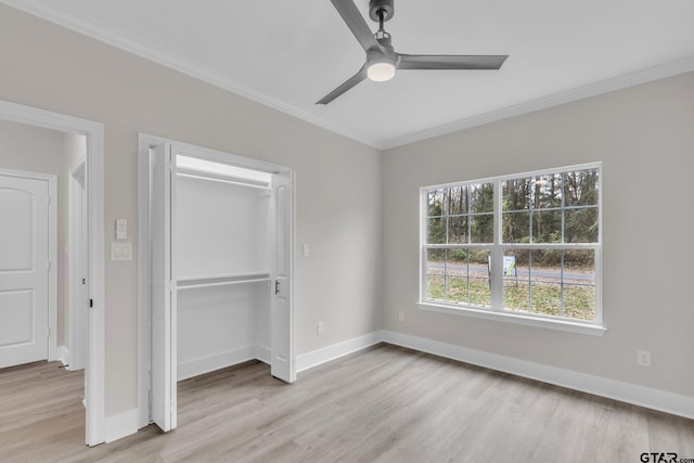 unfurnished bedroom featuring ceiling fan, light hardwood / wood-style floors, crown molding, and multiple windows