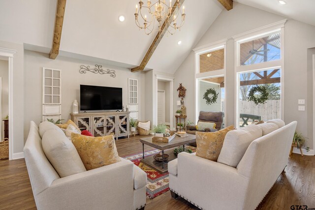 living room featuring dark wood-type flooring, high vaulted ceiling, a notable chandelier, and beamed ceiling