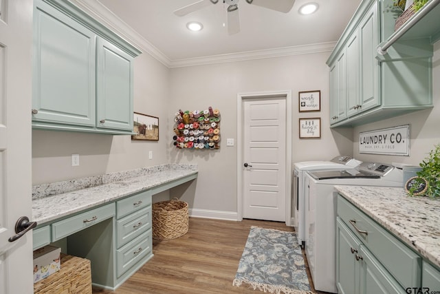 washroom with washer and dryer, light hardwood / wood-style flooring, cabinets, and crown molding