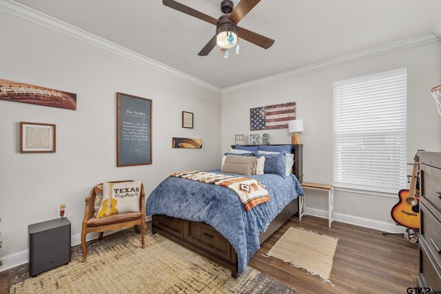 bedroom featuring dark hardwood / wood-style flooring, ceiling fan, and ornamental molding