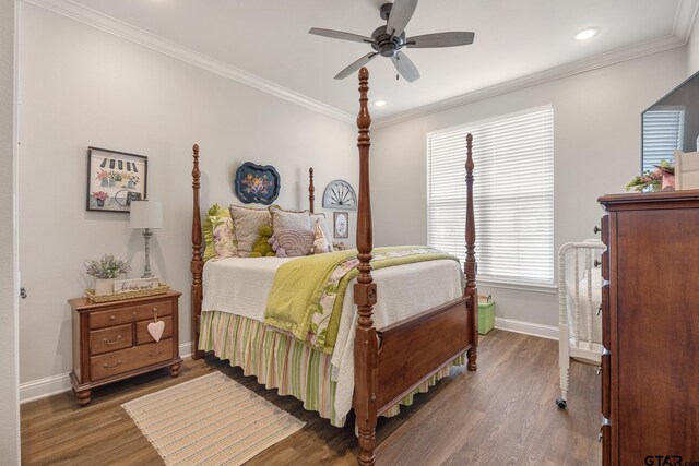 bedroom featuring dark wood-type flooring, ceiling fan, and ornamental molding