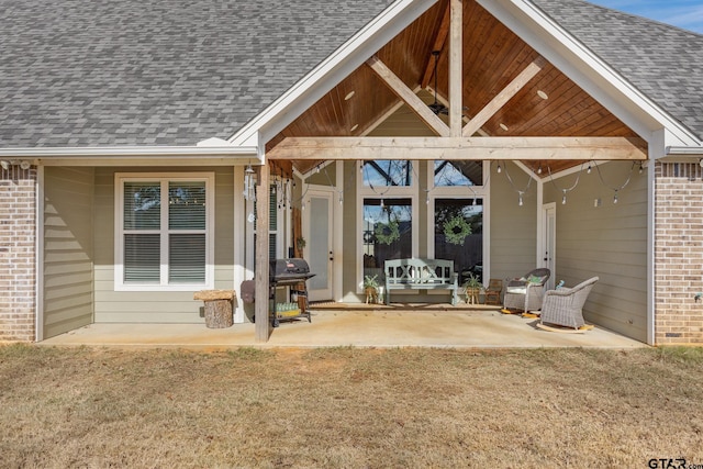 doorway to property featuring a patio and a yard