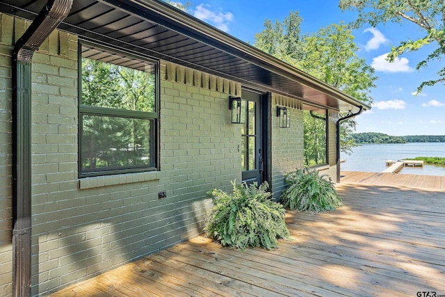 view of side of home featuring a deck with water view