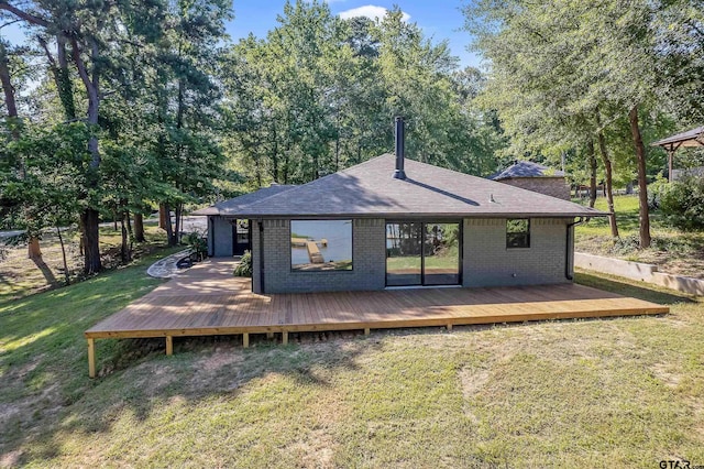 rear view of house featuring a lawn and a wooden deck