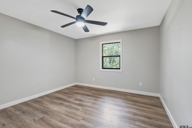 spare room with wood-type flooring and ceiling fan