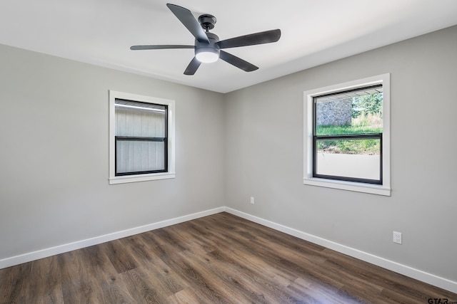 unfurnished room with ceiling fan and dark wood-type flooring