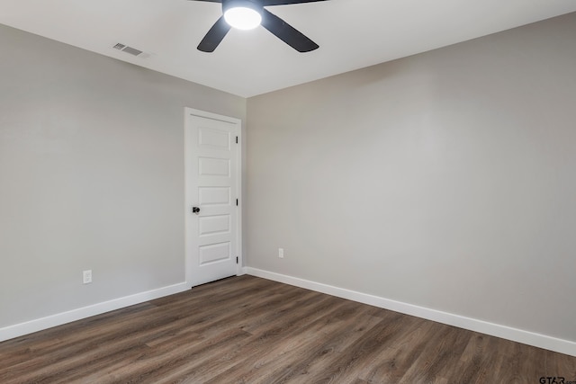 empty room featuring ceiling fan and dark hardwood / wood-style flooring