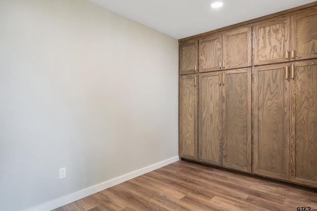 unfurnished bedroom with a closet and light hardwood / wood-style floors