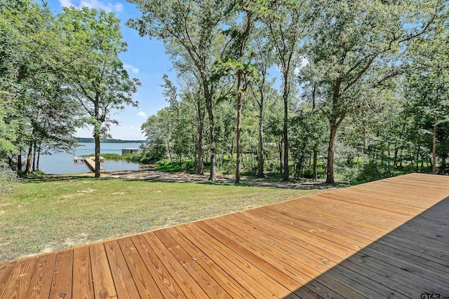 wooden deck with a yard and a water view