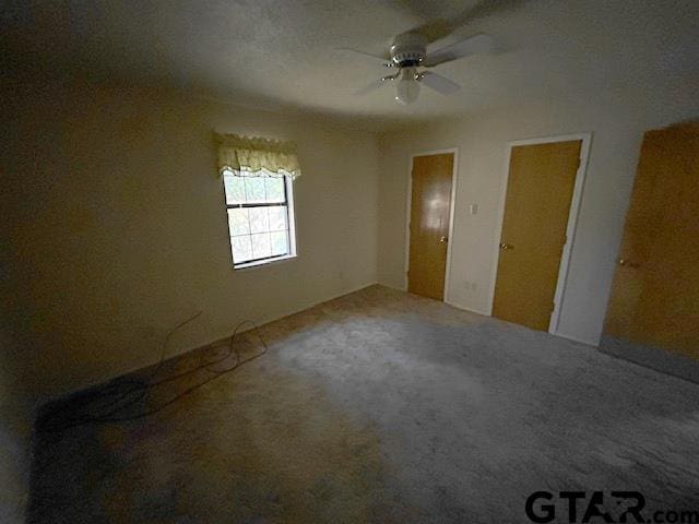 unfurnished bedroom featuring carpet flooring and ceiling fan