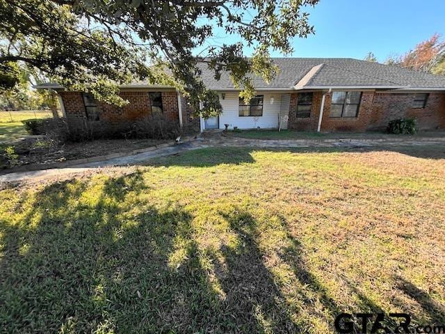 ranch-style house with a front lawn