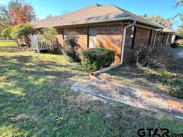 view of side of home featuring a yard