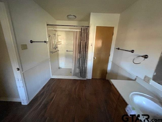 bathroom featuring wood-type flooring, vanity, and walk in shower