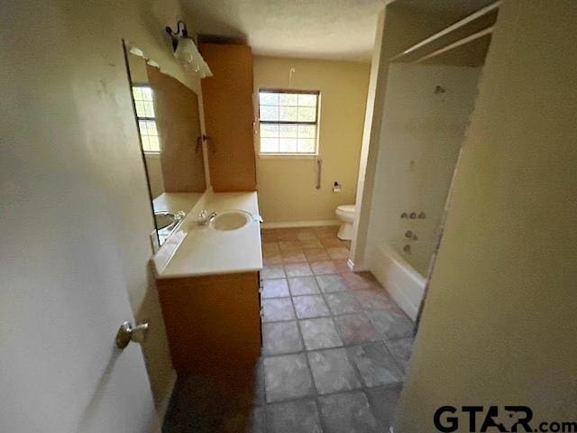 full bathroom featuring shower / bathing tub combination, vanity, and toilet