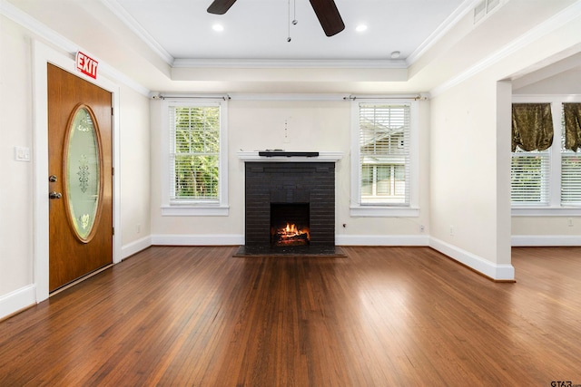 unfurnished living room with a fireplace, a wealth of natural light, hardwood / wood-style flooring, and crown molding