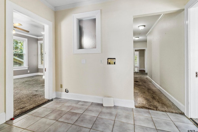 corridor with ornamental molding and light carpet