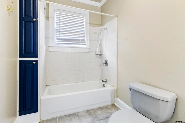 bathroom featuring ornamental molding, tiled shower / bath combo, tile patterned floors, and toilet