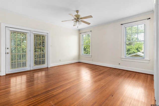 empty room featuring hardwood / wood-style flooring, ceiling fan, and ornamental molding