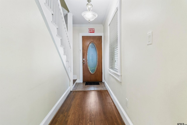 doorway with hardwood / wood-style floors and ornamental molding