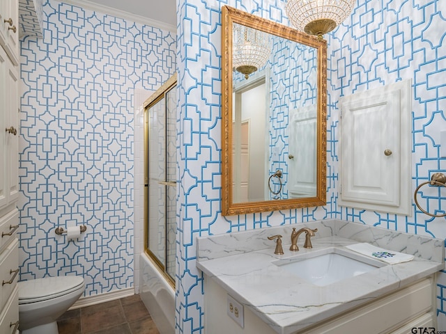 full bathroom featuring ornamental molding, enclosed tub / shower combo, vanity, and toilet