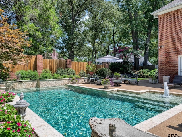 view of swimming pool with a patio area and pool water feature